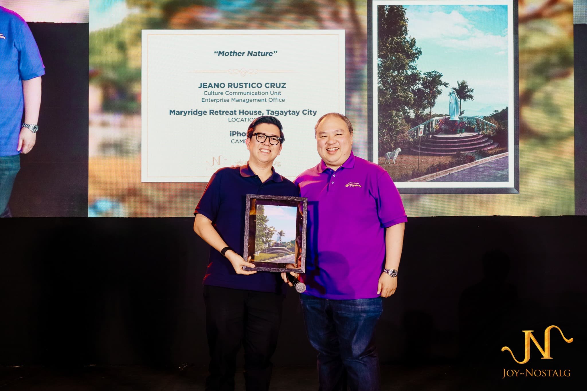 An employee receiving a photography award at a company event