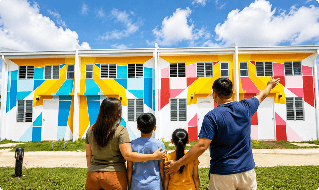 A Filipino family looking at colorful new homes